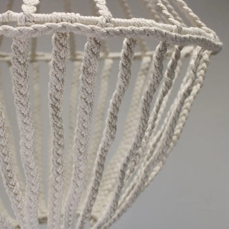 A delicate off-white macrame large drop cotton rope chandelier with an intricate woven pattern and cotton rope material