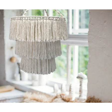 Beige macrame chandelier made of soft cotton rope with tiered fringe for natural boho lighting decor