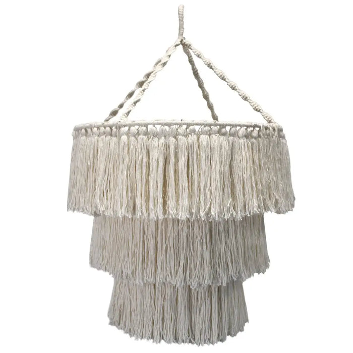 Cream-colored macrame chandelier with three tiered fringe layers made of soft cotton rope hanging indoors