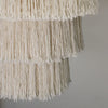 Off-white macrame chandelier with layered fringe made of thick cotton rope strands in natural soft cotton rope design
