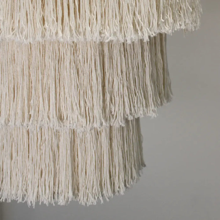 Off-white macrame chandelier with layered fringe made of thick cotton rope strands in natural soft cotton rope design