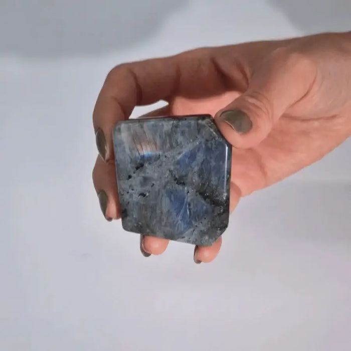 A polished square-cut madagascar labradorite tomb stone 5-7cm with blue color and silver gray iridescent flashes
