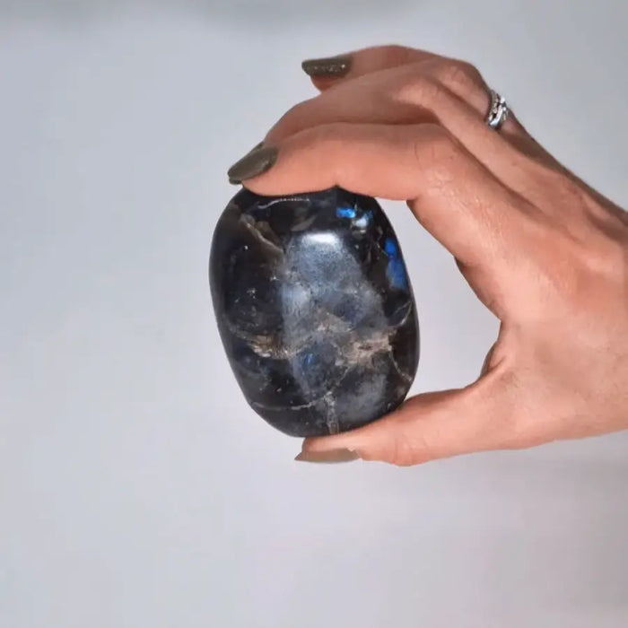 A smooth oval madagascar labradorite tomb stone with deep blue and silver iridescence 5-7cm 80-100gm