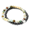A double-strand magnetic gemstone bracelet with black magnetic beads and multicolored jade-like stones with silver clasp