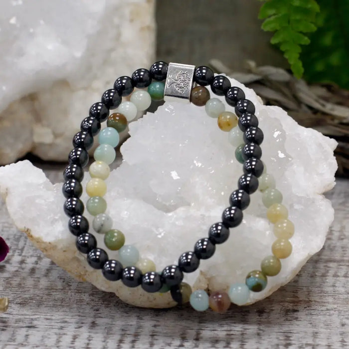 A double-strand magnetic gemstone bracelet with black magnetic beads and multicolored jade stones with silver clasp