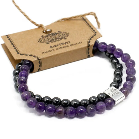 Purple and black amethyst magnetic gemstone bracelet with a silver tree design clasp on a white background