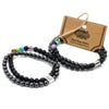 Magnetic gemstone bracelet with black stone beads and colorful chakra stones in a polished finish