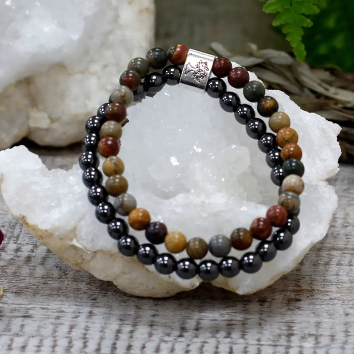 A magnetic gemstone bracelet with black hematite and earthy picasso jasper beads and a silver tree clasp