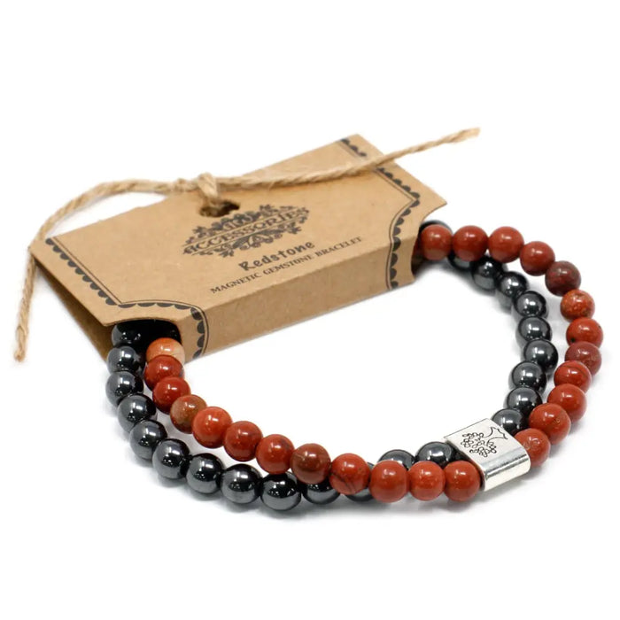 Red and black magnetic gemstone bracelet with a silver-toned engraved rectangular clasp called redstone