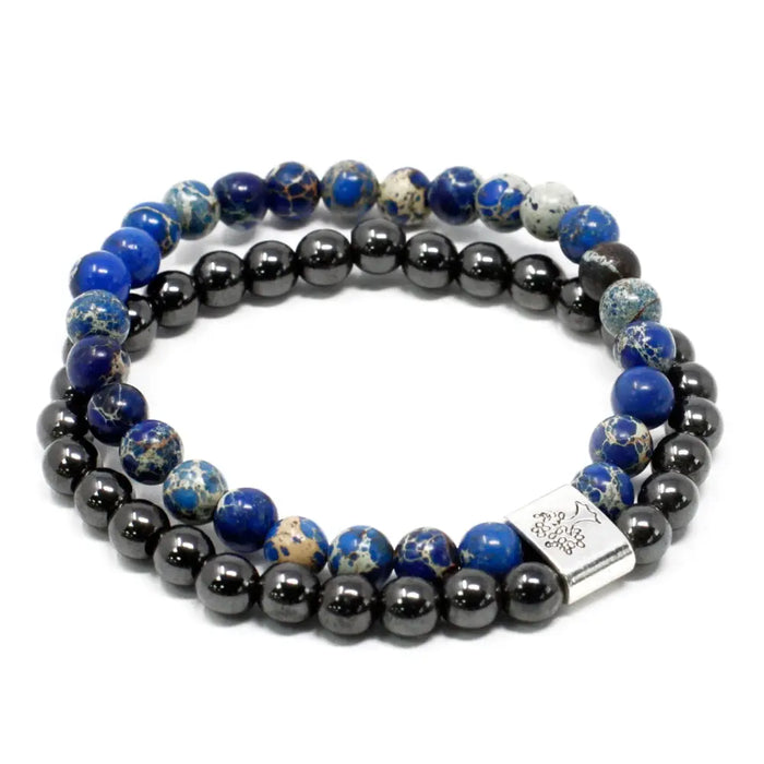 A double-strand magnetic gemstone bracelet with blue lapis lazuli and black hematite beads and a silver floral clasp