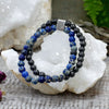 A double-strand magnetic gemstone bracelet with blue sodalite and black beads and a silver tree engraved clasp