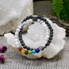 A magnetic gemstone double-strand bracelet with black and white howlite beads and seven colorful chakra stones