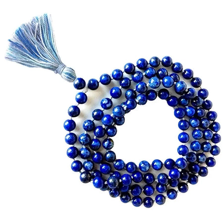 A coiled string of deep blue lapis lazuli mala beads with a matching tassel at one end