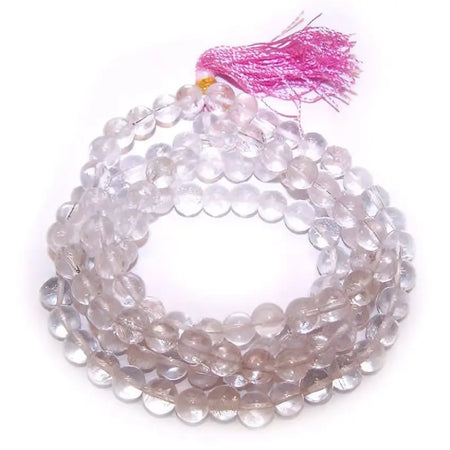 A clear quartz mala beads bracelet with a soft pink tassel made from rock crystal beads