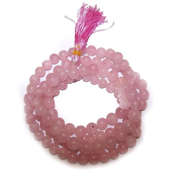 A delicate pink rose quartz mala beads bracelet with matching tassel made from smooth stone beads