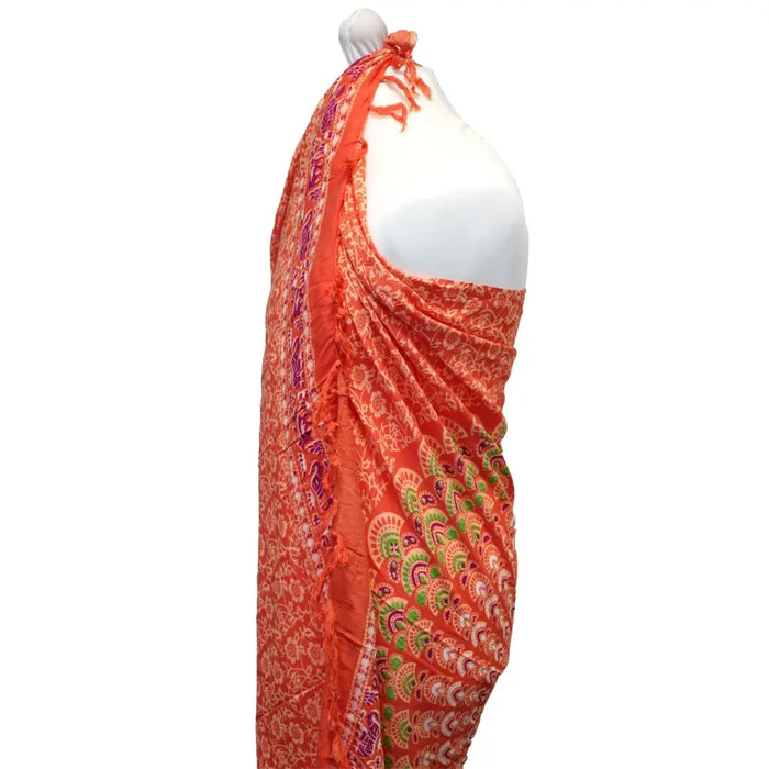 Vibrant orange mandala sarong with fringed edge and pink rose paisley floral patterns in purple green and white