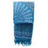 A teal orange mandala sarong with intricate blue and white patterns and purple elephant border with fringed edges