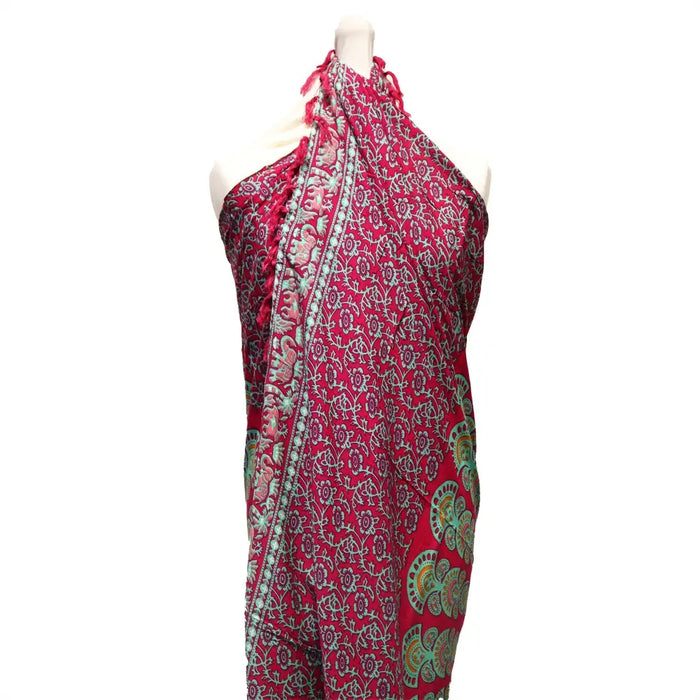 A vibrant teal purple mandala sarong wrap dress with fuchsia base and floral circular patterns in muted tones