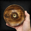 Handcrafted mango wood incense burner disc with natural grain, engraved yin yang symbol, and brass central chamber
