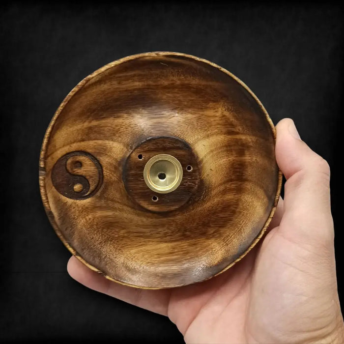 Handcrafted mango wood incense burner disc with natural grain, engraved yin yang symbol, and brass central chamber