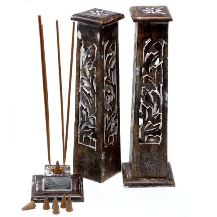 Two dark brown mango wood incense towers with tapered square tops and carved floral patterns in whitewash finish