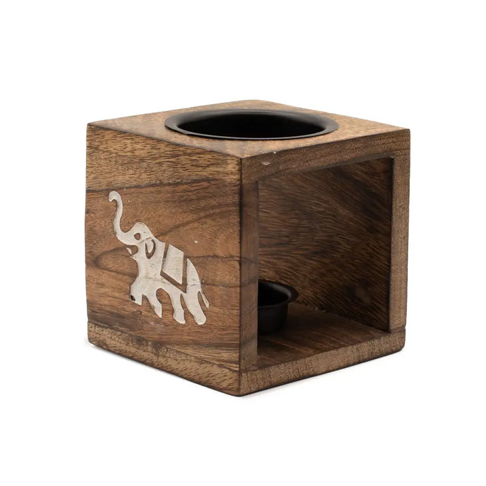 Brown mango wood oil burner cube with inset white elephant design and two black circular compartments