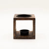 Dark brown mango wood oil burner cube with two black circular compartments for holding oils and candles