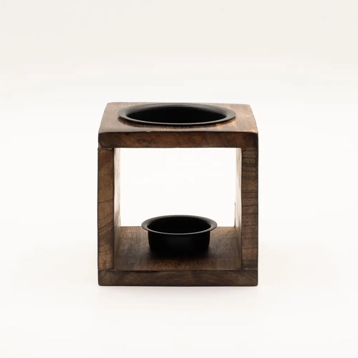 Dark brown mango wood oil burner cube with two black circular compartments for holding oils and candles