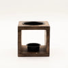 Dark wood mango wood oil burner in cube shape with yin yang black circular compartments on top and bottom