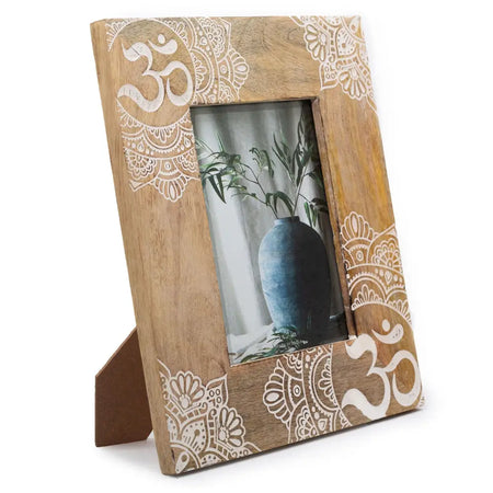 Rustic mango wood picture frame with white hand-painted om symbols and mandala patterns showing natural wood grain
