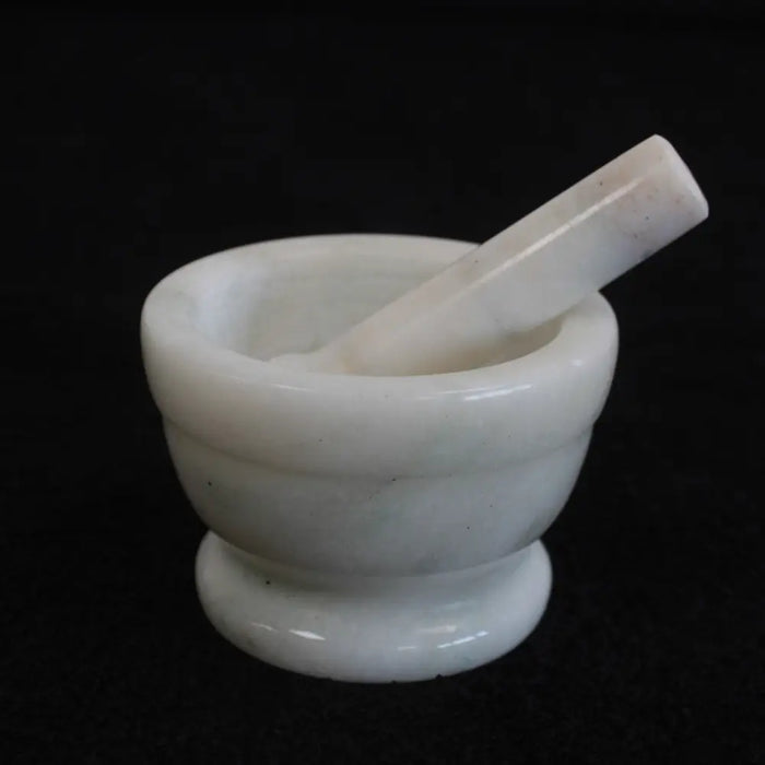 Medium white marble mortar and pestle set made of smooth stone for grinding and crushing ingredients