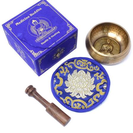 Golden brass medicine buddha singing bowl 10cm with embossed buddha figure and blue gold embroidered cushion