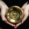 Golden brass medicine buddha singing bowl 10cm with detailed embossed buddha figure at the center
