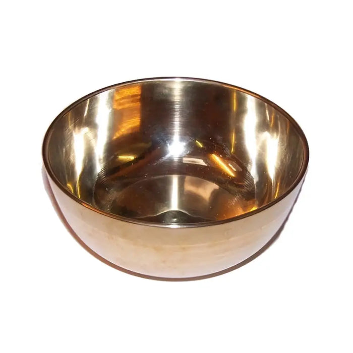 Medium brass singing bowl with polished smooth reflective interior and slightly rounded rim used for meditation and sound therapy