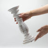 Medium whitewash candle stand made of distressed mango wood with turned design and fluted base for candles