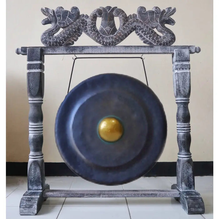 Medium black gong with golden center on a carved wooden stand featuring dragon heads 50cm diameter