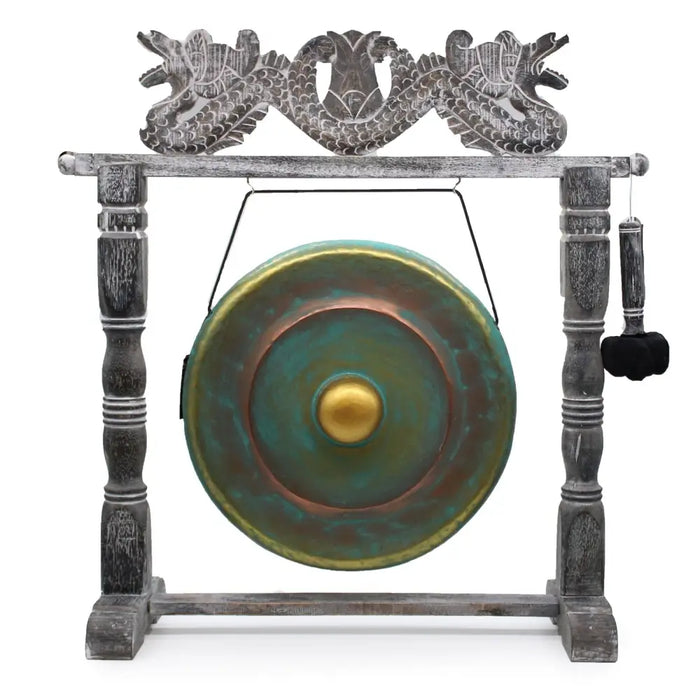 Medium 50cm bronze gong with verdigris patina and golden center on a carved wooden dragon stand with green wash finish