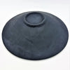 A matte black medium mosaic tile dish handcrafted from ceramic with a smooth, slightly textured surface and central indent