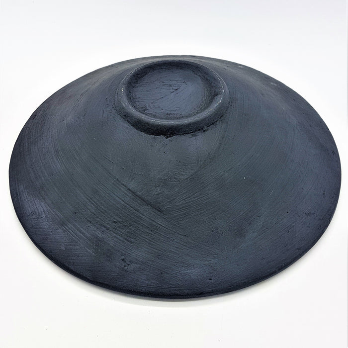 A matte black medium mosaic tile dish handcrafted from ceramic with a smooth, slightly textured surface and central indent