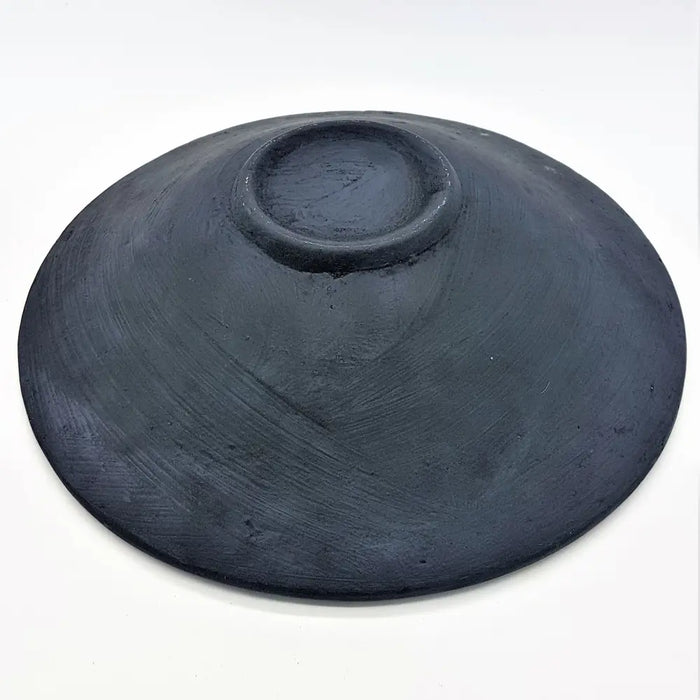 A matte black medium mosaic tile dish handcrafted from ceramic with a smooth, slightly textured surface and central indent