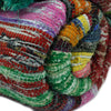 Medium green rag rug made from chunky multicolored fabric strips in a textured woven design