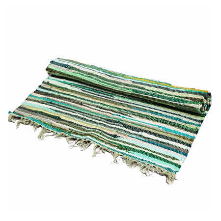 A rolled-up medium rag rug with natural greens stripes in green and teal woven fabric with frayed edges