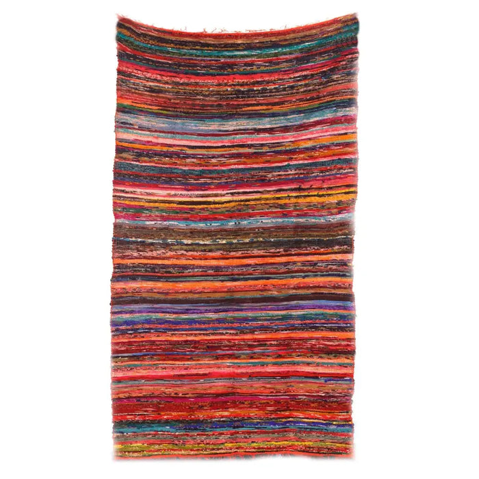 Medium rag rug with handwoven horizontal stripes in reds oranges blues and earthy tones made of rag rugs material