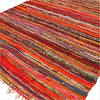 Medium rag rug with bold red and orange stripes and multicolored accents made from handwoven fabric