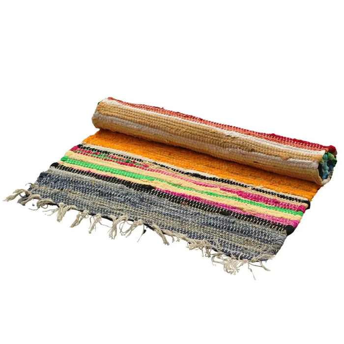 Medium rag rug made of handwoven fabric with rainbow colours and frayed edges rolled up on one side
