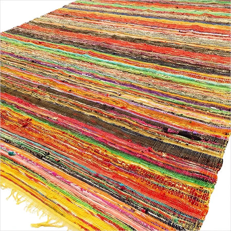 Medium yellow rag rug with vibrant striped pattern made from recycled fabric strips and frayed edges