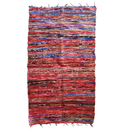 Medium velvet dari rag rug in vibrant red and blue stripes made from woven materials with frayed edges