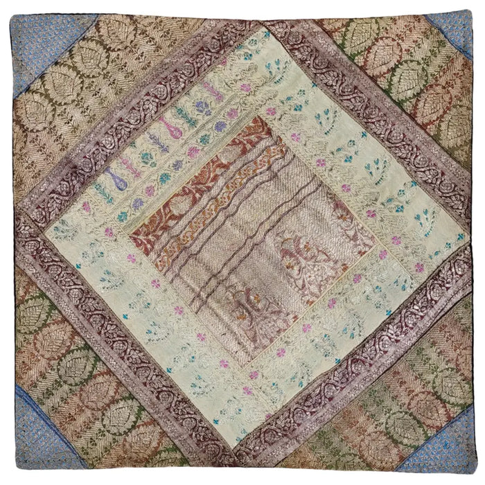 A square patchwork cushion cover in cream burgundy and green with metallic thread and floral embroidery borders