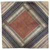 A patchwork cushion cover with a rust diamond and metallic thread details in black beige silver and muted tones