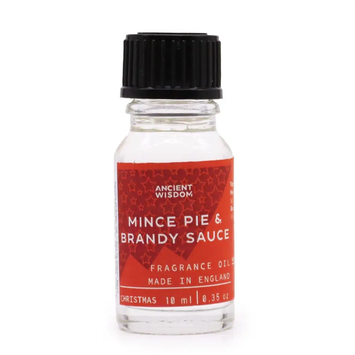 A clear glass bottle of ancient wisdom mince pie and brandy sauce fragrance oil with allergen declarations label